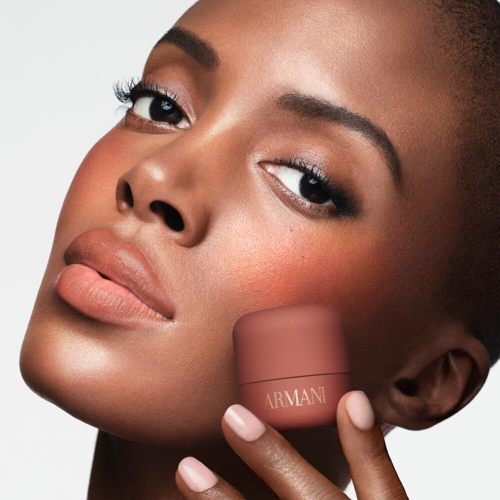 Madisin holding ARMANI Beauty DOLCI blush near her cheek, showing a warm blush result