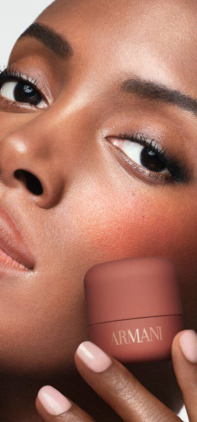 Madisin holding ARMANI Beauty DOLCI blush near her cheek, showing a warm blush result