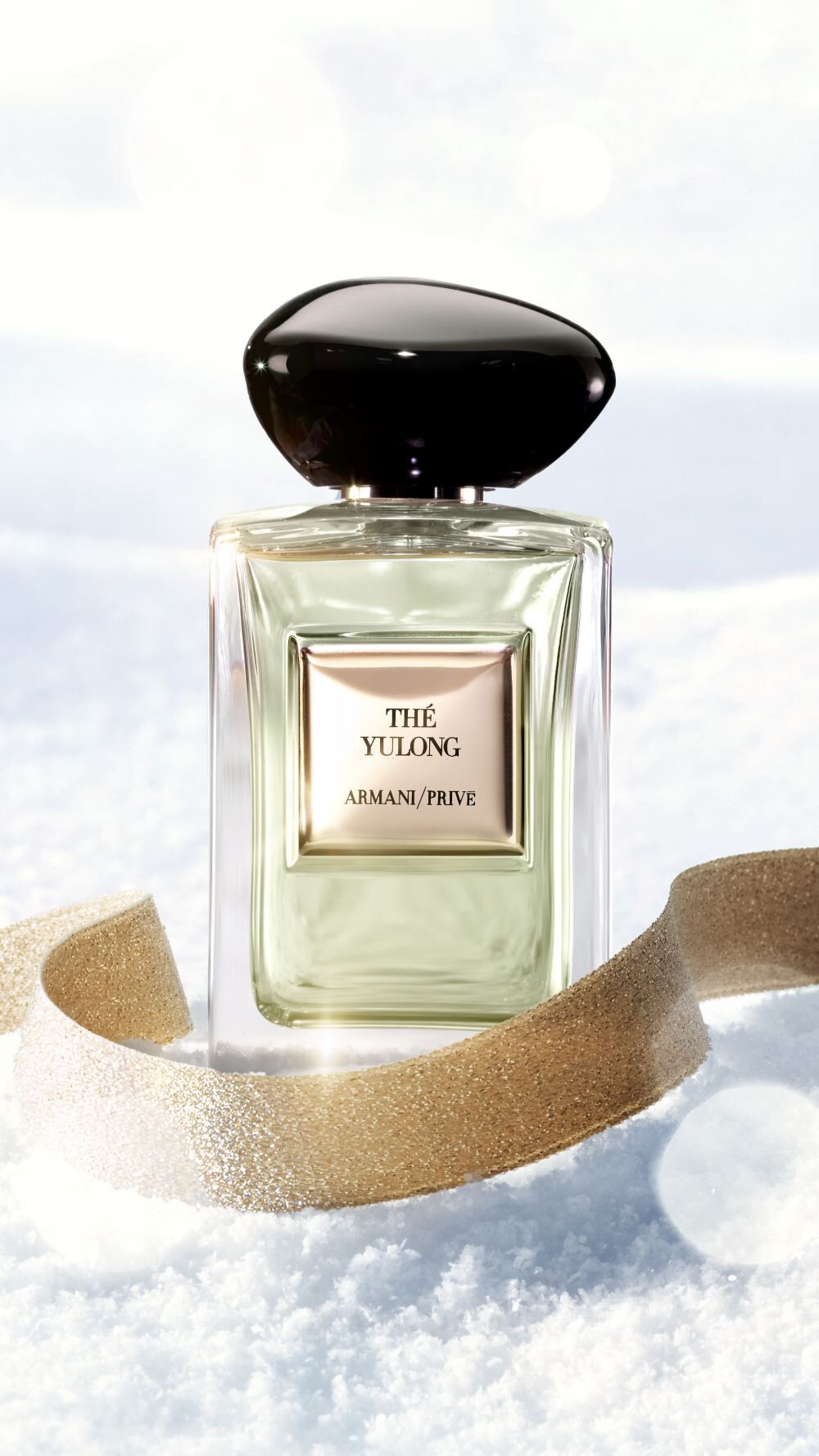 Armani/Prive The Yulong fragrance on snow with a gold ribbon for the holiday season. 