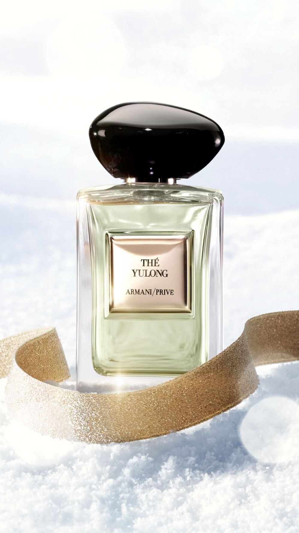 Armani/Prive The Yulong fragrance on snow with a gold ribbon for the holiday season.