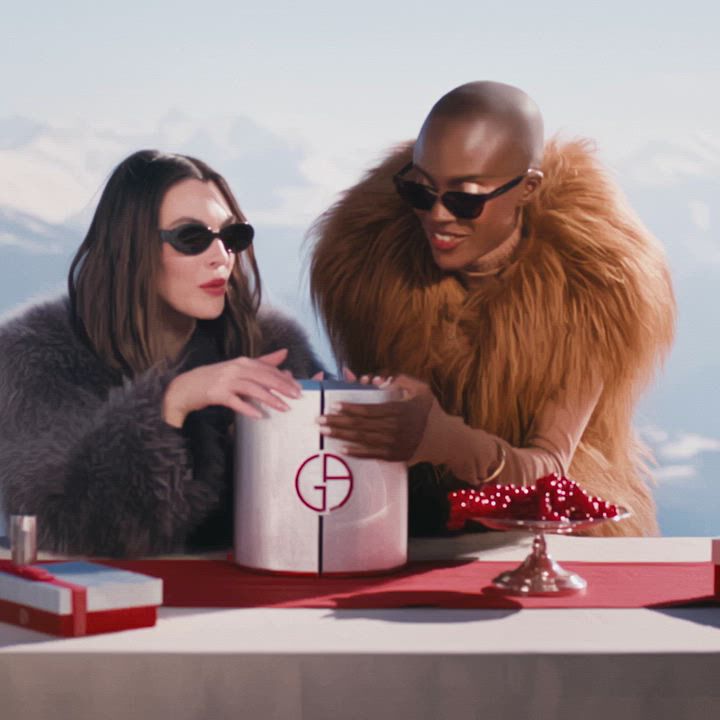 Vittoria Ceretti and Madisin Rian opening the Armani beauty Advent Calendar in an alpine holiday setting.