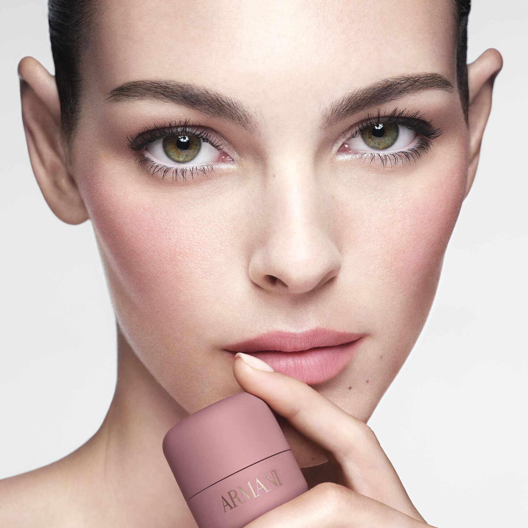 Vittoria holding ARMANI Beauty DOLCI blush near her face, showing a soft pink blush result on cheeks
