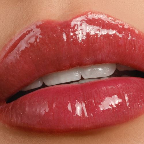 Armani Prisma Flash 44 Heat Flash lipstick on lips, displaying a fiery red shade with a bold, glossy finish.