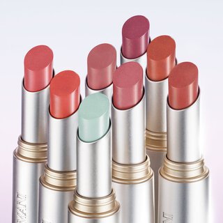 Armani Prisma Flash lipstick collection displayed upright, featuring a variety of vibrant and pastel shades in sleek metallic tubes.