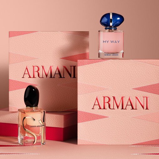 Armani gift sets featuring Si and My Way Eau de Parfum bottles, displayed with elegant pink and red Armani Mother's Day boxes on a matching geometric background.