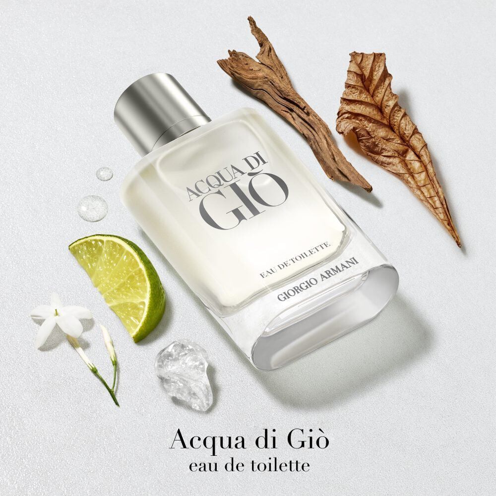 Giorgio Armani Acqua di Gio Eau de Toilette — clear glass signature bottle emerging from icy water with fresh lime and aquatic elements, evoking the freshness of the Mediterranean sea.