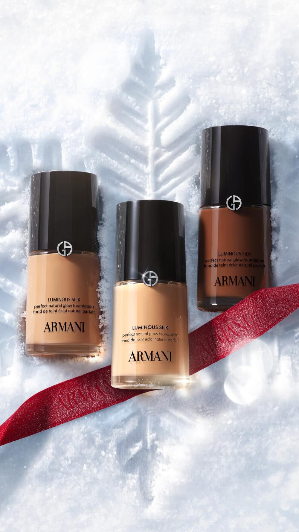 Armani beauty make-up products on snow for the Holiday 2026 winter glamour campaign.