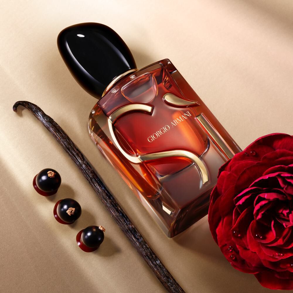 Giorgio Armani Si Parfum bottle with a red rose, vanilla pod and dark berries.
