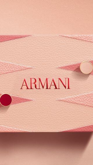 Luxury Armani Mother's Day gift set featuring a pink leather-textured box with backgammon geometric patterns. Inside, a Giorgio Armani "Si EDP" perfume bottle and travel size fragrance.