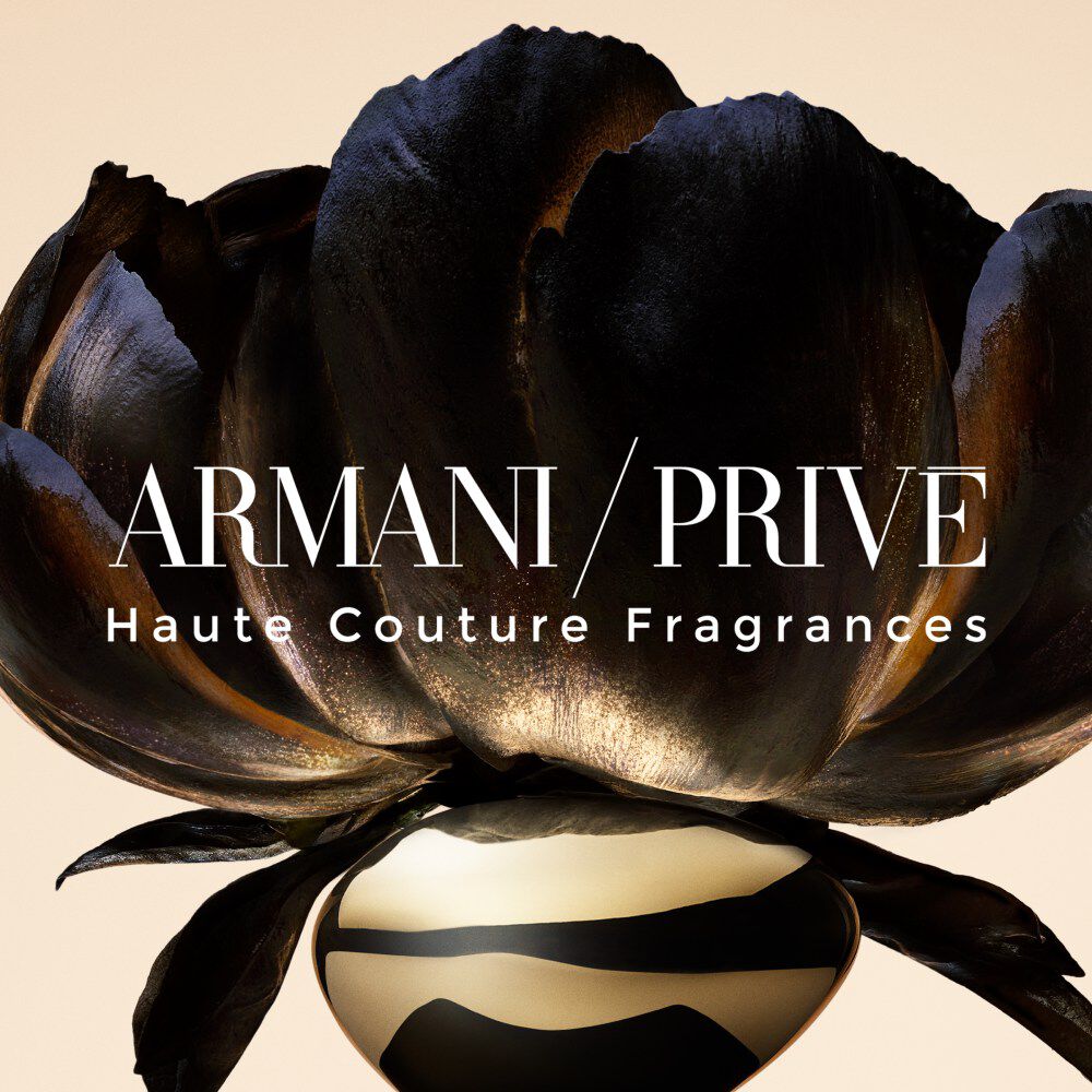 Armani/Prive Scent Finder key visual featuring a close-up of a dark, velvety flower with subtle gold highlights on a soft beige background, overlaid with the white ‘ARMANI/PRIVE’
