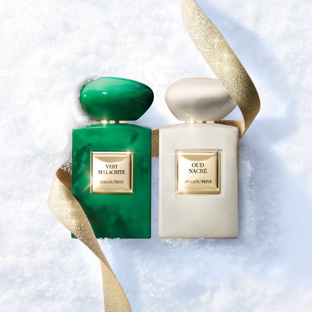 Armani/Prive Les Terres Precieuses fragrances on snow with a golden ribbon.