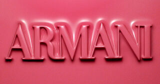 ARMANI logo embossed in pink blush texture above a visual of all ARMANI Beauty DOLCI blush shades