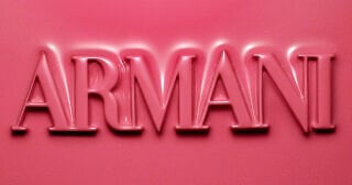 ARMANI logo embossed in pink blush texture above a visual of all ARMANI Beauty DOLCI blush shades