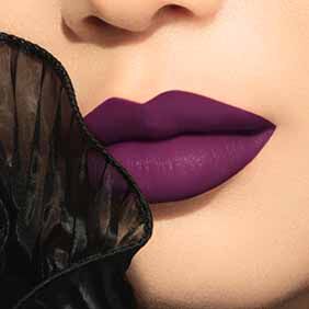 Close-up of lips wearing ARMANI LIP MAESTRO shade 001 Deep Plum, framed by black sheer fabric.