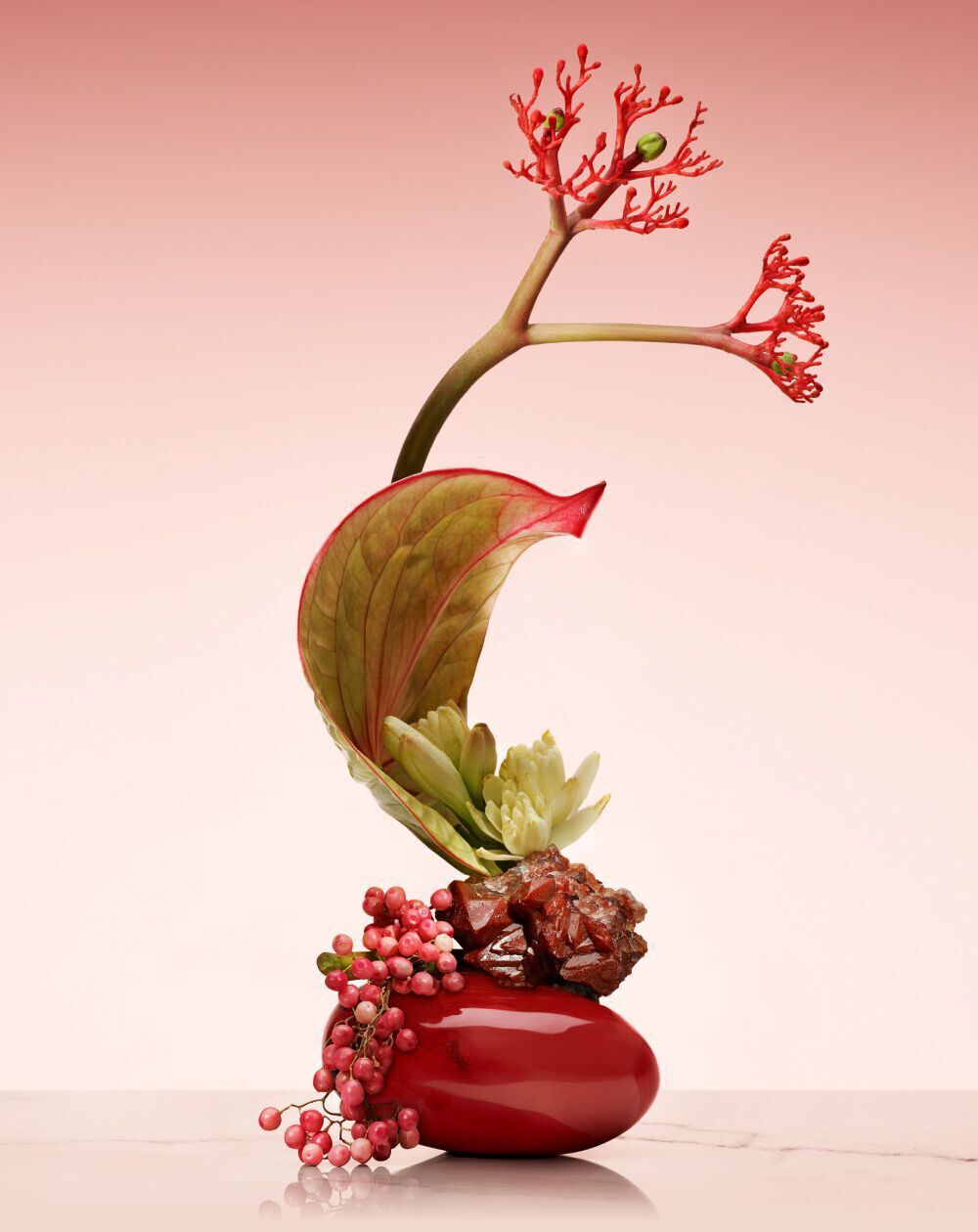 Armani/Prive Rouge Malachite: artistic ikebana arrangement with red florals and green accents, showcasing elevated craftsmanship.