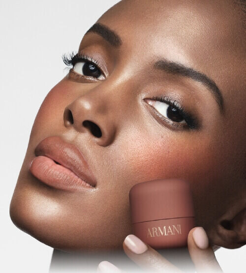 Madisin holding ARMANI Beauty DOLCI blush near her cheek, showing a warm blush result