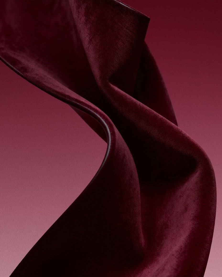 Burgundy fabric texture inspired by the sensual leather accord.