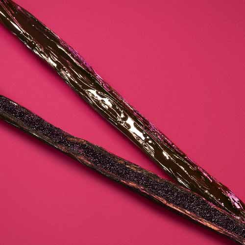 Vanilla beans on a deep ruby background — addictive vanilla absolute base note of Power of You Eau de Parfum by Giorgio Armani.