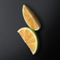 Green mandarin and citrus slices on a dark background — green mandarin top note of Armani Code Eau de Toilette by Giorgio Armani.