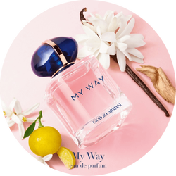 Armani Si EDP bottle with rose, blackcurrant, and white flower on a light background.