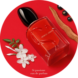 Armani Si Passione EDP red bottle with jasmine, blackcurrant, and cedarwood on a red background.