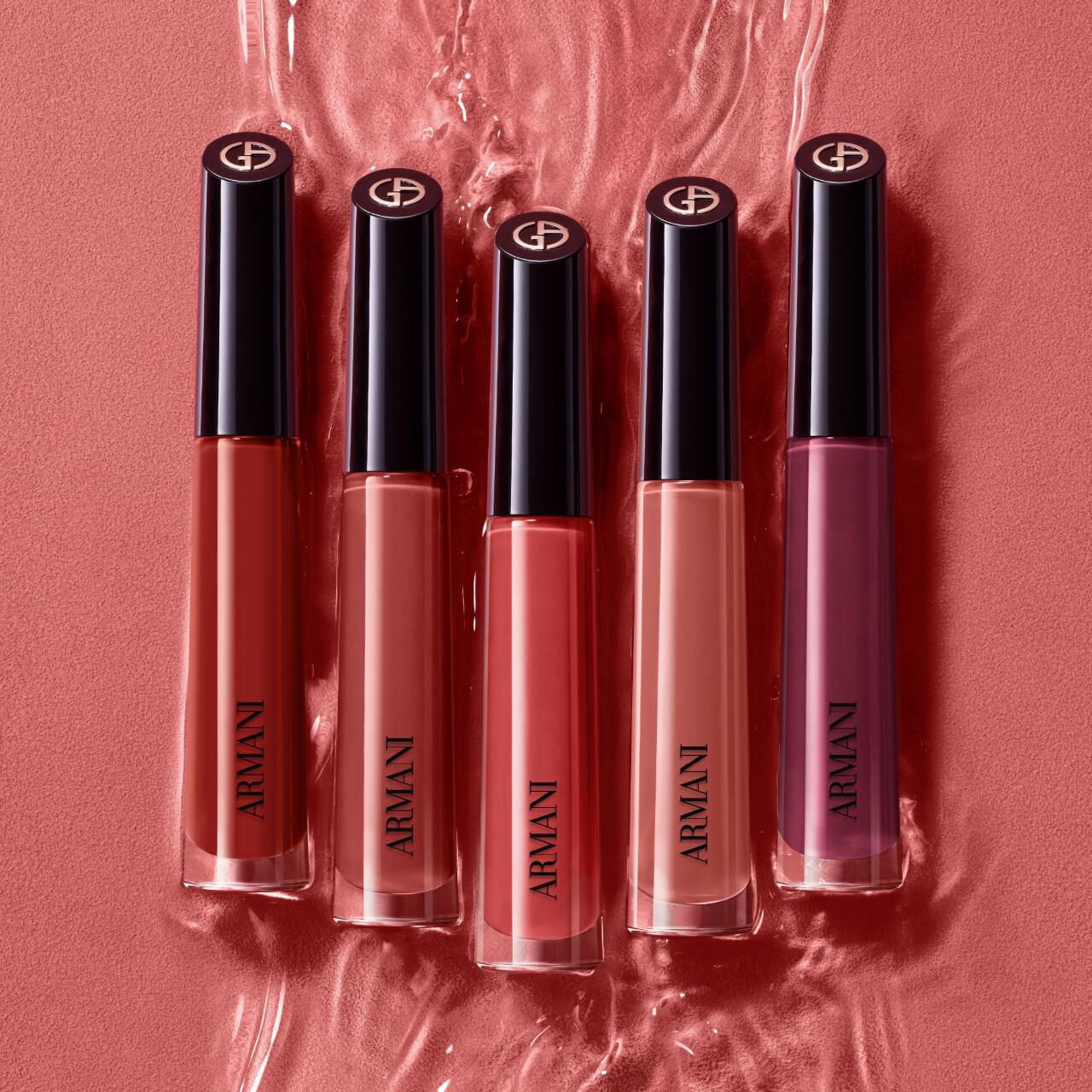Split image showing a close-up of Vittoria wearing dusty rose ARMANI LIP MAESTRO and five lipstick shades arranged on a rippled pink background.