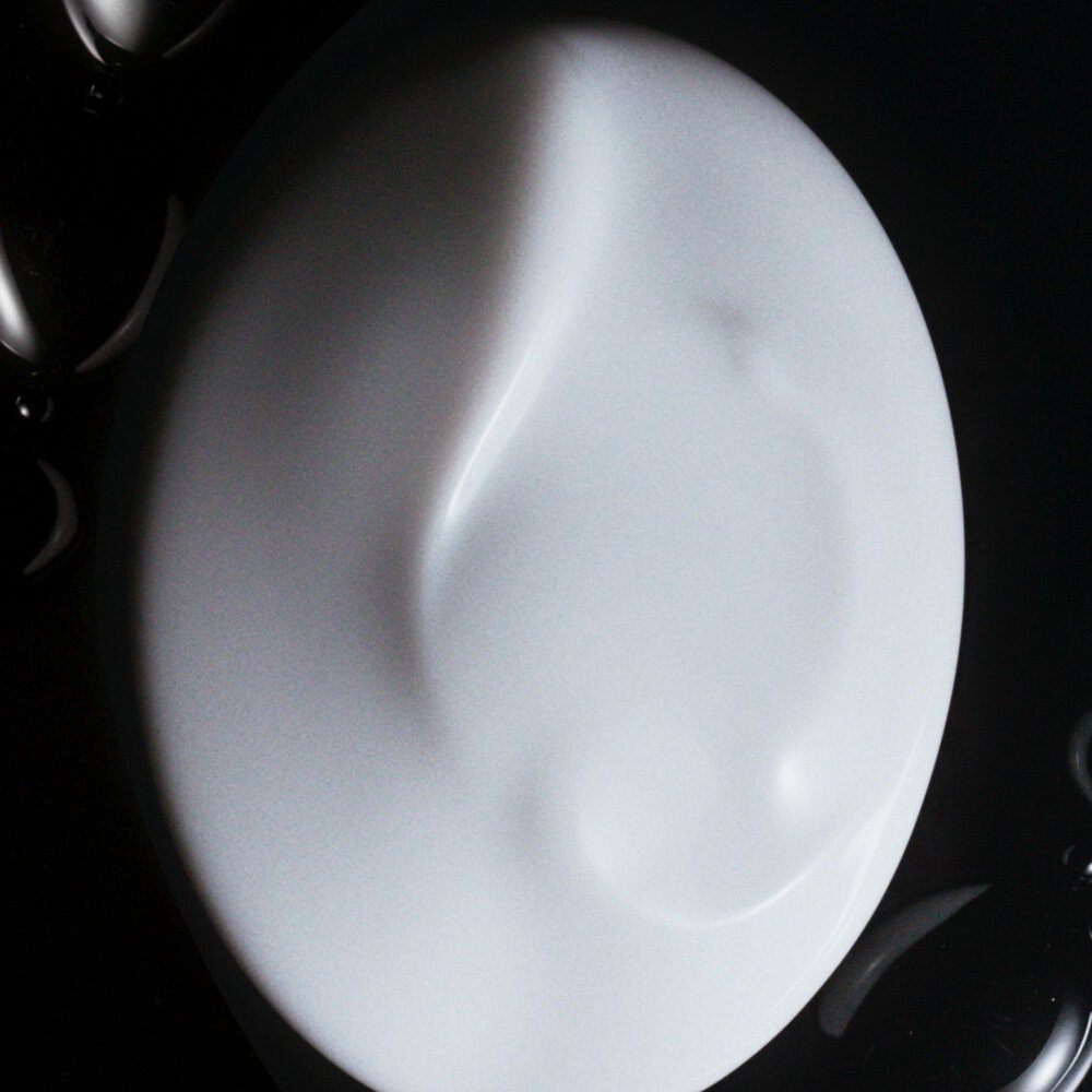 Close-up of the silky white texture of Armani beauty THE HAND CREAM.
