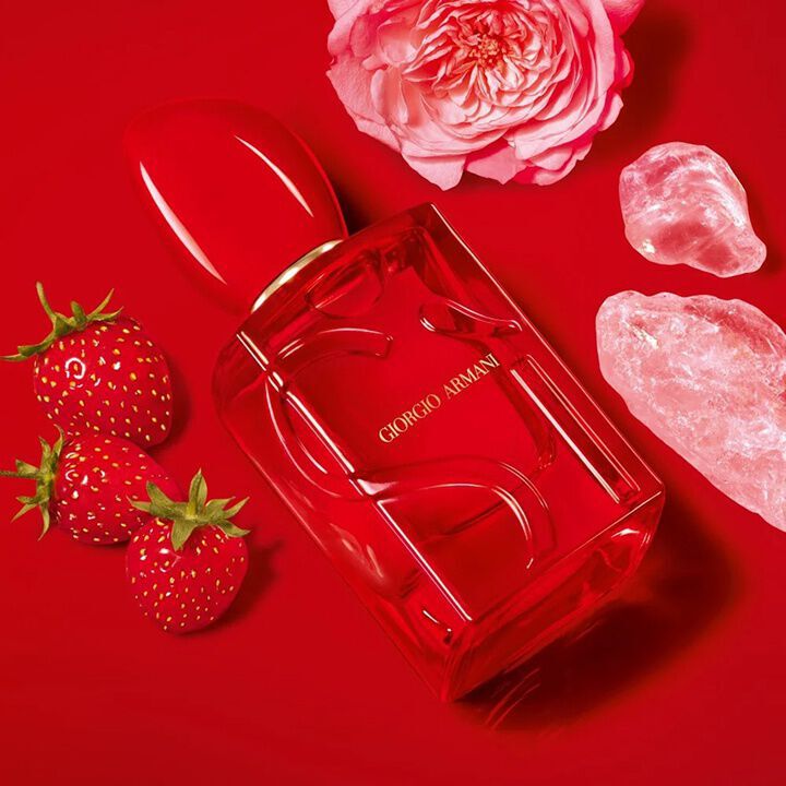 Giorgio Armani Si Eau de Parfum Red Musk bottle with strawberries, rose and pink crystals.