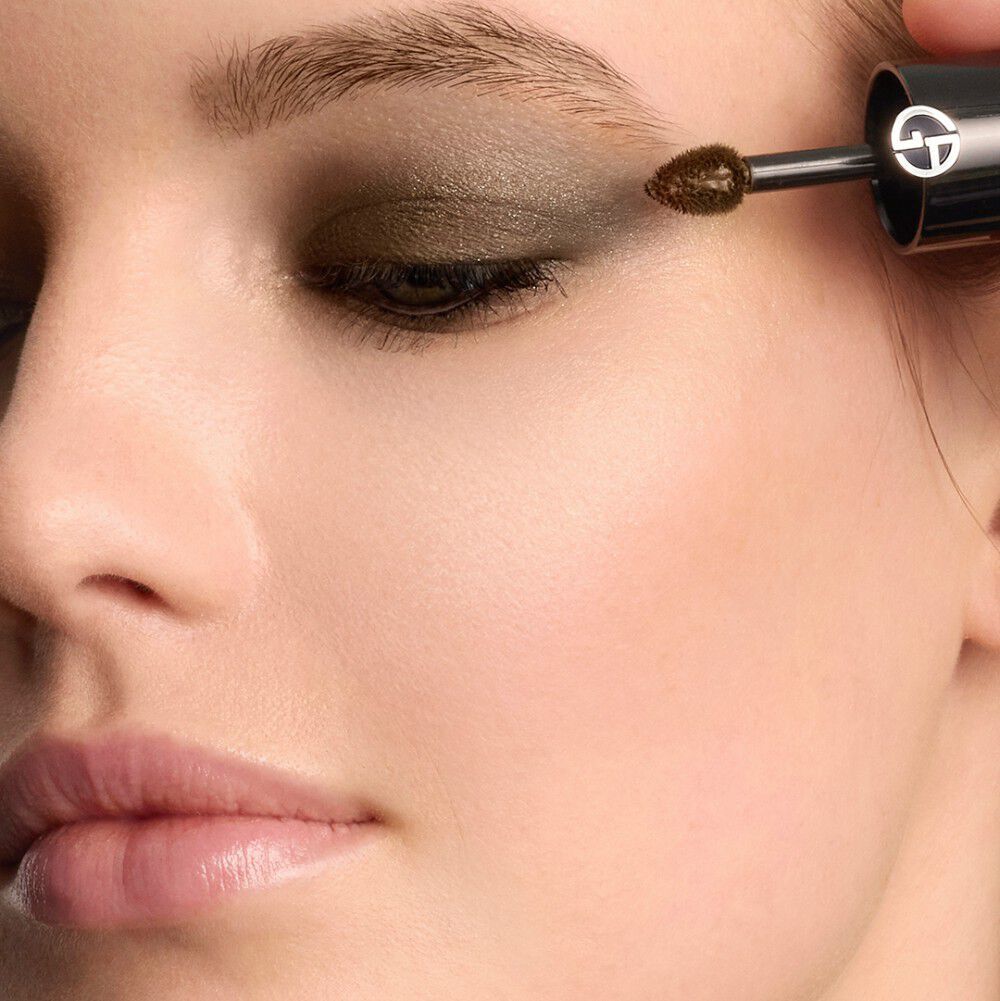 A woman applies EYE TINT