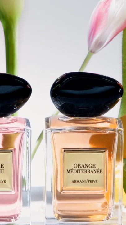 Armani Prive luxury fragrance collections: Les Eaux in clear glass, Les Terres Precieuses in vibrant green and red, and Les Mille et Une Nuits in elegant black bottles with gold caps, reflecting exquisite craftsmanship and storytelling.