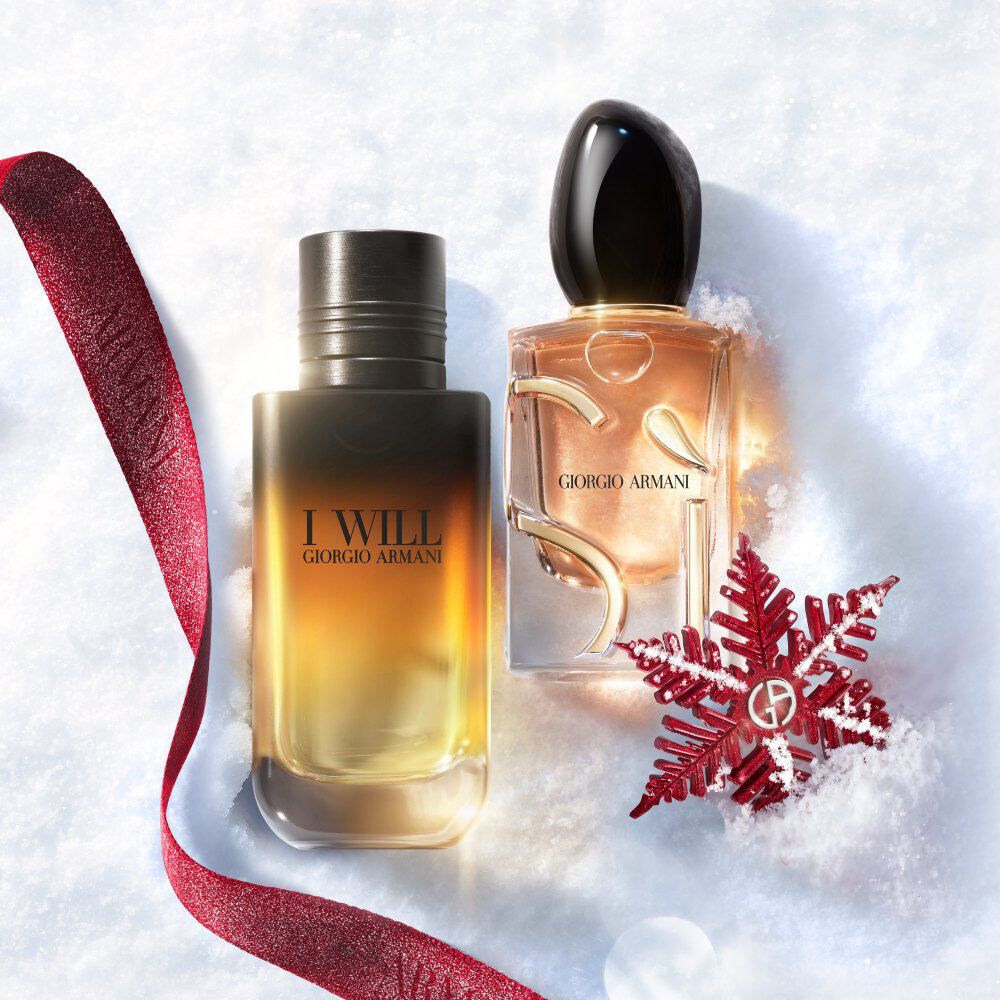 Giorgio Armani I Will and Si fragrances on snow with a red ribbon for a holiday gift duo. 