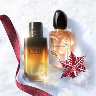 Giorgio Armani I Will and Si fragrances on snow with a red ribbon for a holiday gift duo.