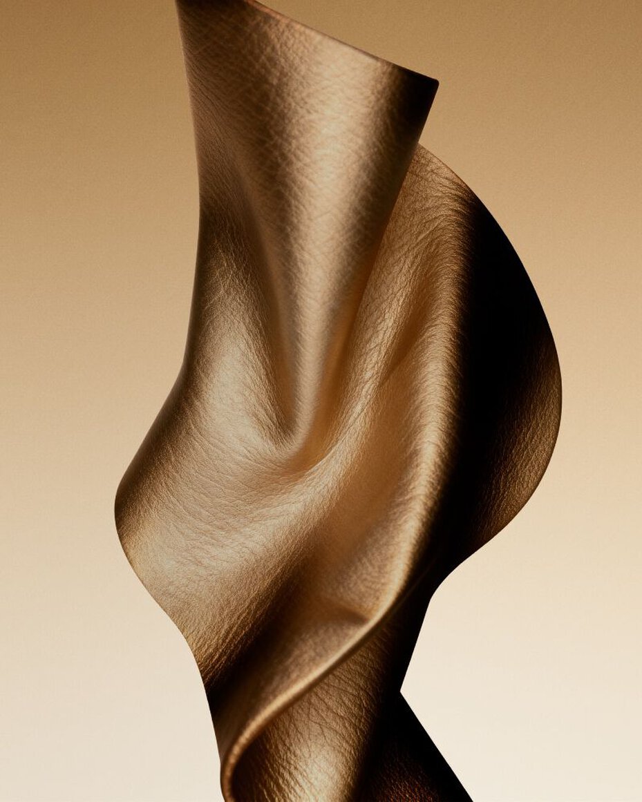 Golden fabric texture inspired by the sensual leather accord.