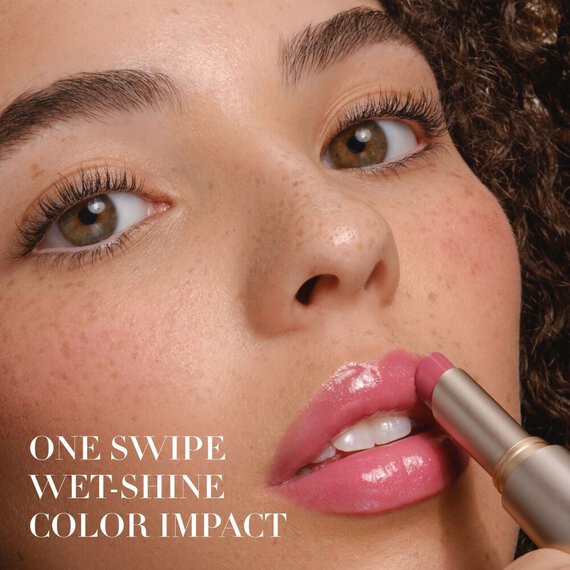 Armani Prisma Flash lip balm being applied, highlighting its luminous, shimmery finish and luxurious texture
