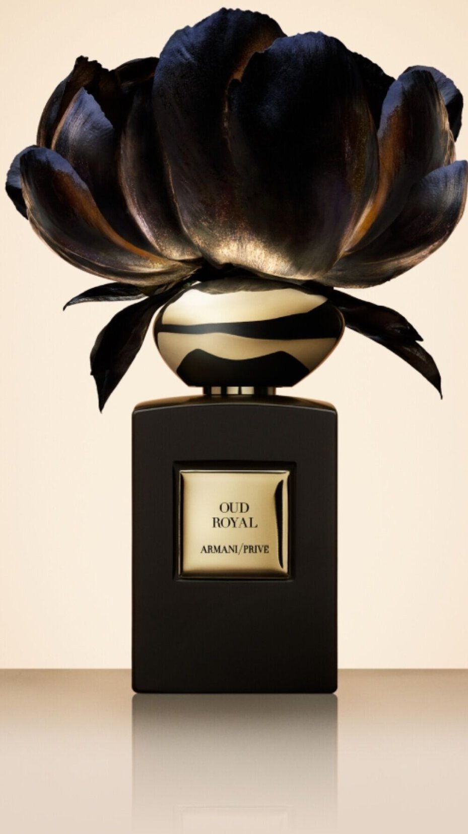 Armani/Prive Oud Royal: luxurious black and gold bottle crowned with a dramatic metallic flower, embodying the fragrance’s opulent and artistic elegance.