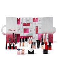 An open Giorgio Armani advent calendar with a wide array of makeup products, fragrances, and mini beauty essentials arranged in front of its numbered doors.	