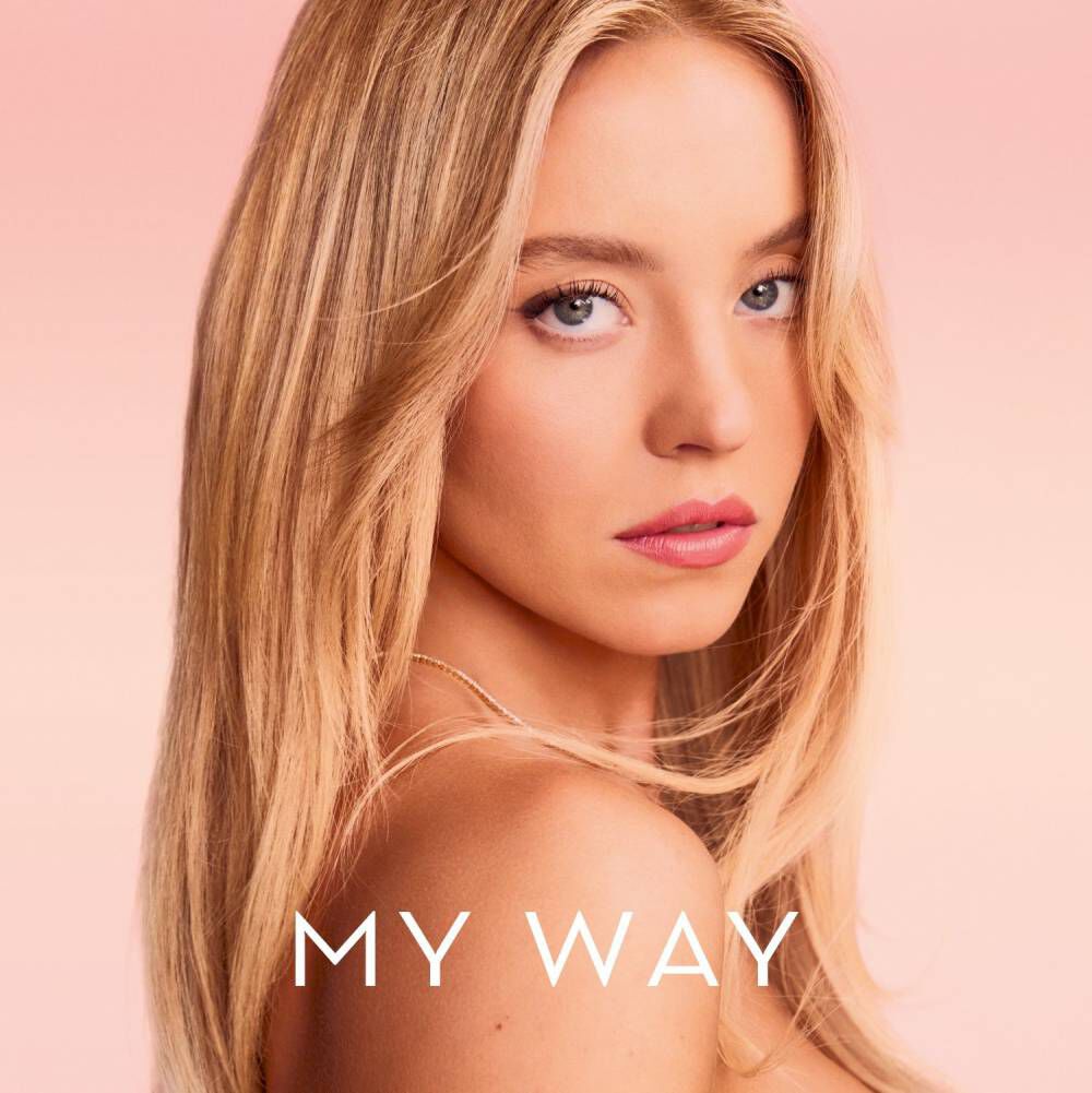 Sydney Sweeny posing against a pink backdrop, with Armani My Way logo displayed beside her.