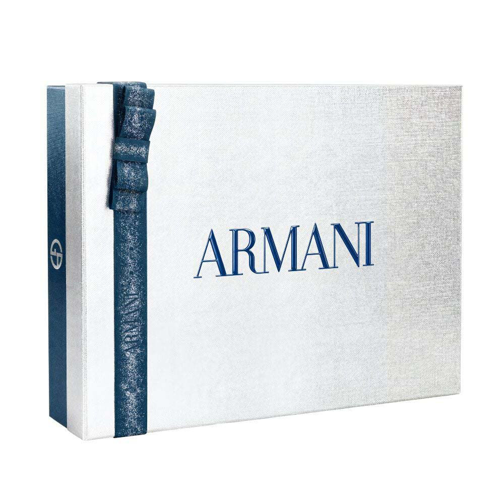 Giorgio Armani Acqua di Gio — white and silver Armani gift box tied with a blue satin ribbon, holiday gifting presentation on a clean white surface.