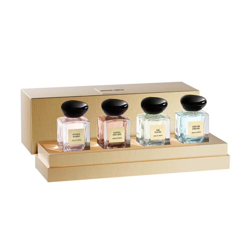 Four Armani Prive Les Eaux miniature eau de parfum bottles with black rounded caps displayed in a row on a white background: Pivoine Suzhou, The Yulong, Vetiver d'Hiver, and Santal Dān Shā.