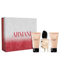Si Eau de Parfum 50ml, Si Eau de Parfum Body lotion 50ml and Si Eau de Parfum Shower Gel 50ml. presented in front of a festive red and silver ARMANI gift box.	