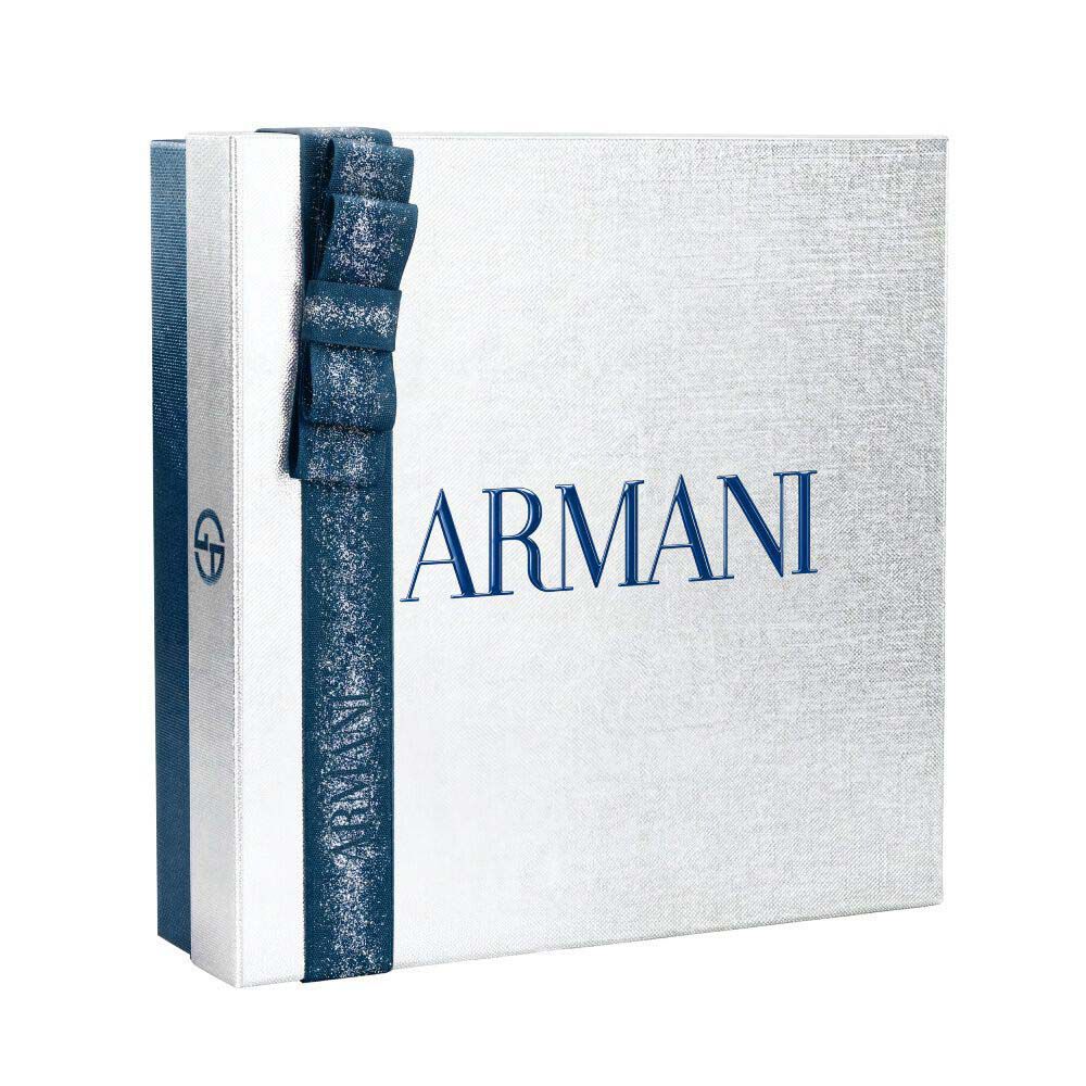Giorgio Armani Acqua di Gio — white and silver Armani gift box tied with a blue satin ribbon, holiday gifting presentation on a clean white surface.