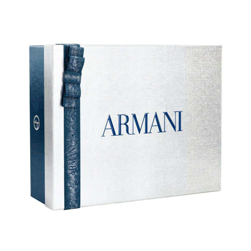 Armani Code— white and silver Armani gift box tied with a blue satin ribbon, holiday gifting presentation on a clean white surface.