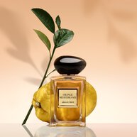 Armani/Prive Orange Mediterranee bottle with a vibrant citron and lush leaves, embodying Mediterranean freshness.