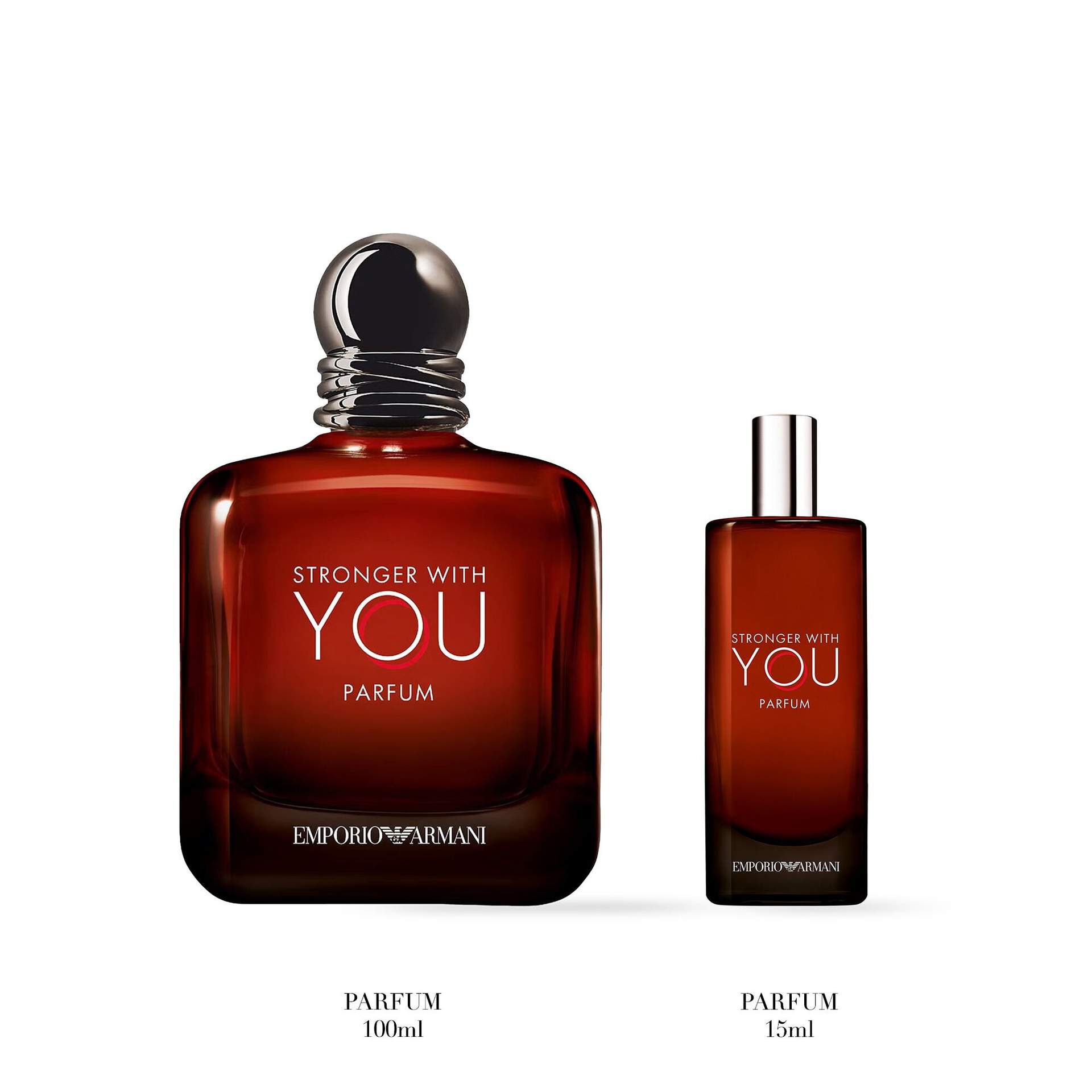 Two Emporio Armani "Stronger With You Parfum" products are displayed on a white background: a large bottle of 100ml parfum and a smaller travel-size 15ml spray, both in deep amber-colored glass.