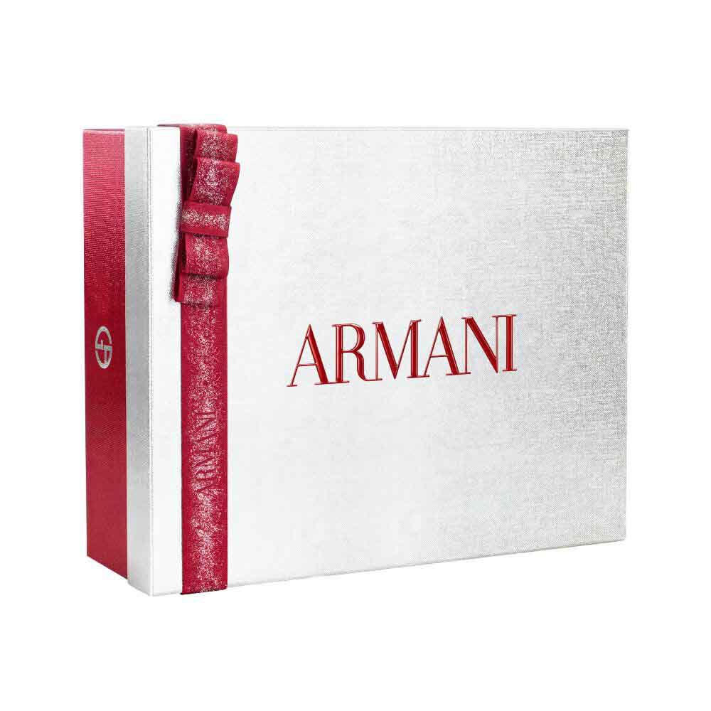 Silver Armani holiday gift box with glittered red ribbon bow — Glamourous Winter Holiday Gift Set Box, white background.