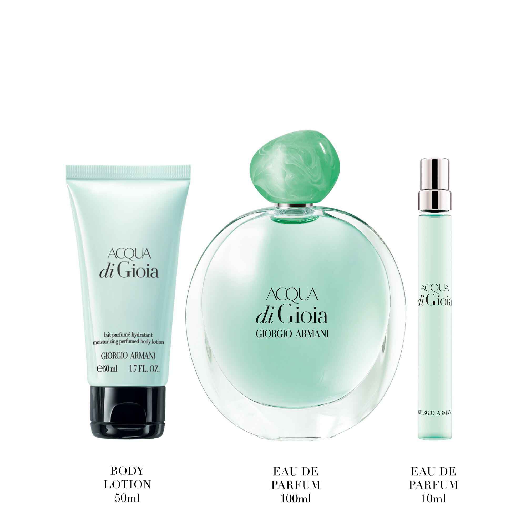 Acqua di Gioia Eau de Parfum 100ml, 10ml and Perfumed Body Lotion 50ml in mint green bottles standing upright — Giorgio Armani women's fragrance and body care gift set, white background.