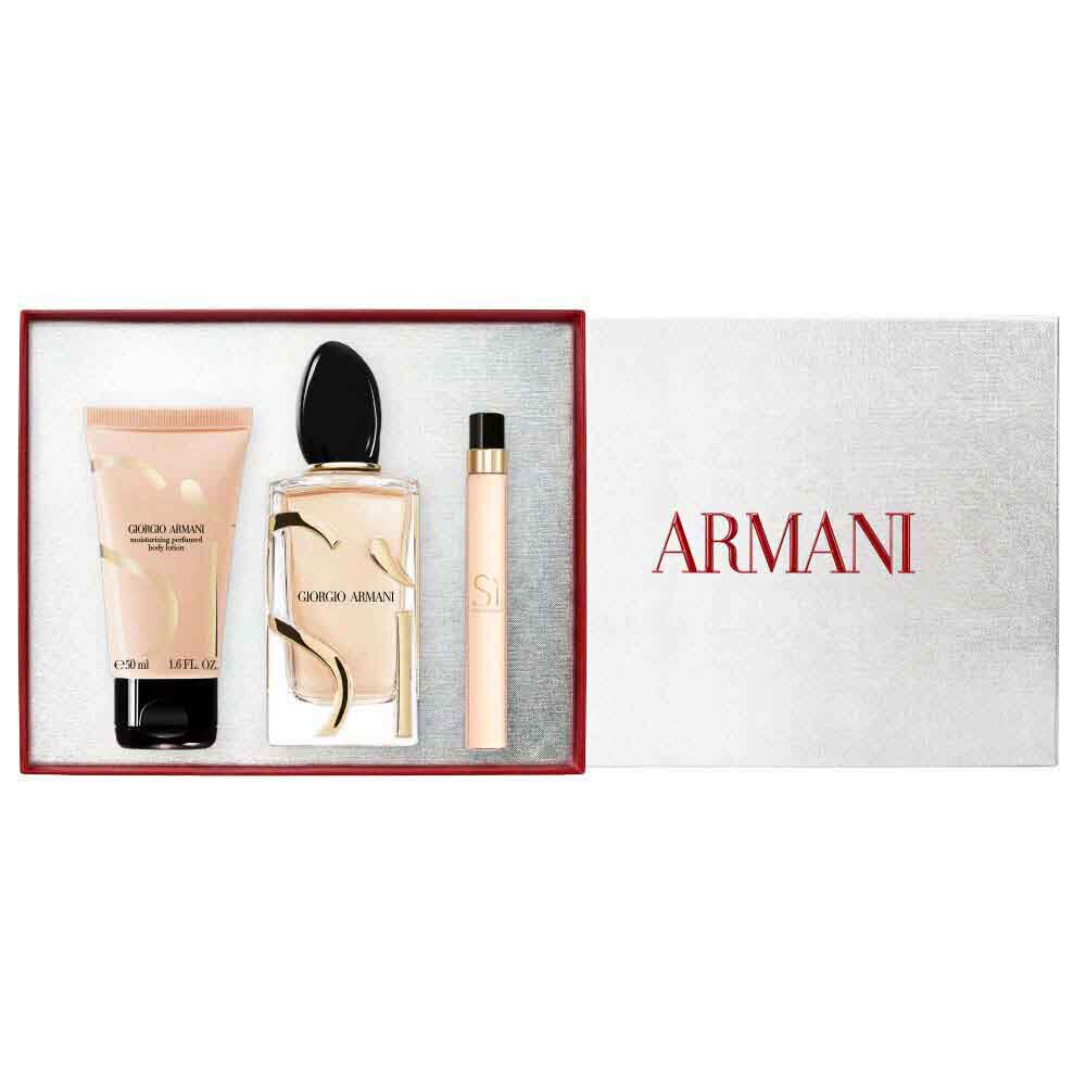 Si Eau de Parfum 100ml, Travel size10ml and 50ml perfumed body lotion gold-toned bottles displayed alongside an open white Armani gift box with red ribbon — women's floral fragrance gift set, white background.