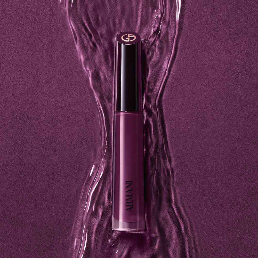 ARMANI LIP MAESTRO in shade 520 Dusty Rose standing upright on a rippled pink background.