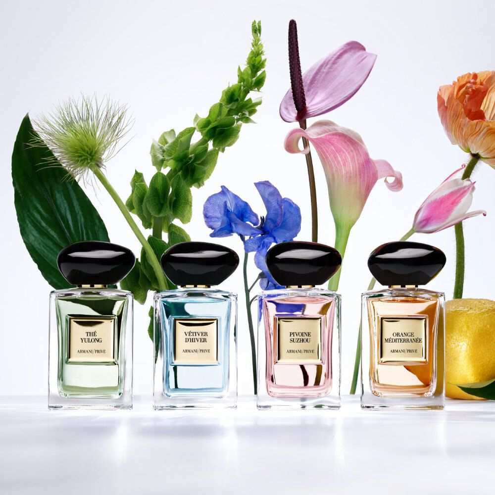 Armani/Prive Les Eaux collection: elegant perfume bottles with botanical accents, arranged in a sophisticated family portrait.