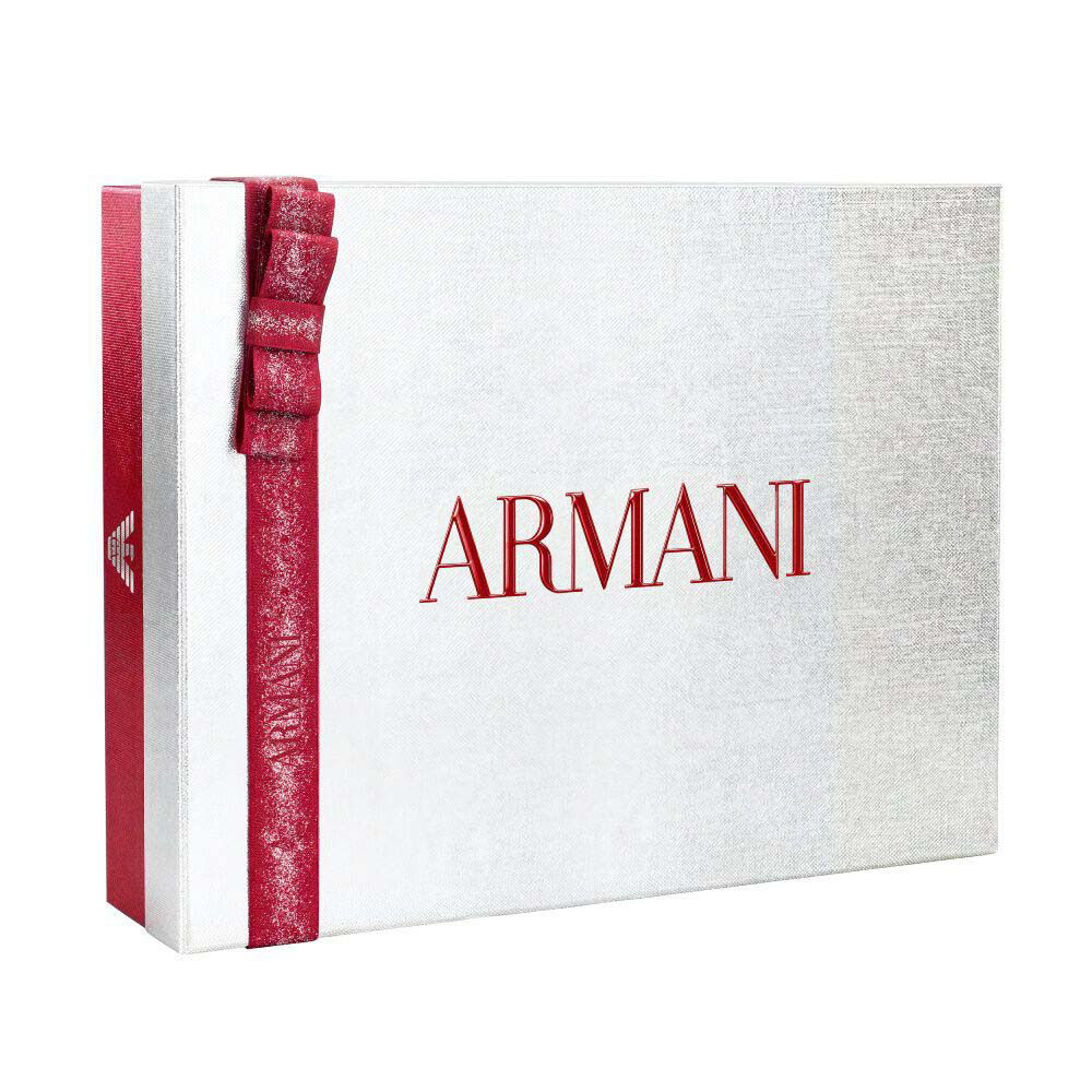 Silver Armani holiday gift box with glittered ruby ribbon bow — Glamourous Winter Holiday Gift Set Box, white background.